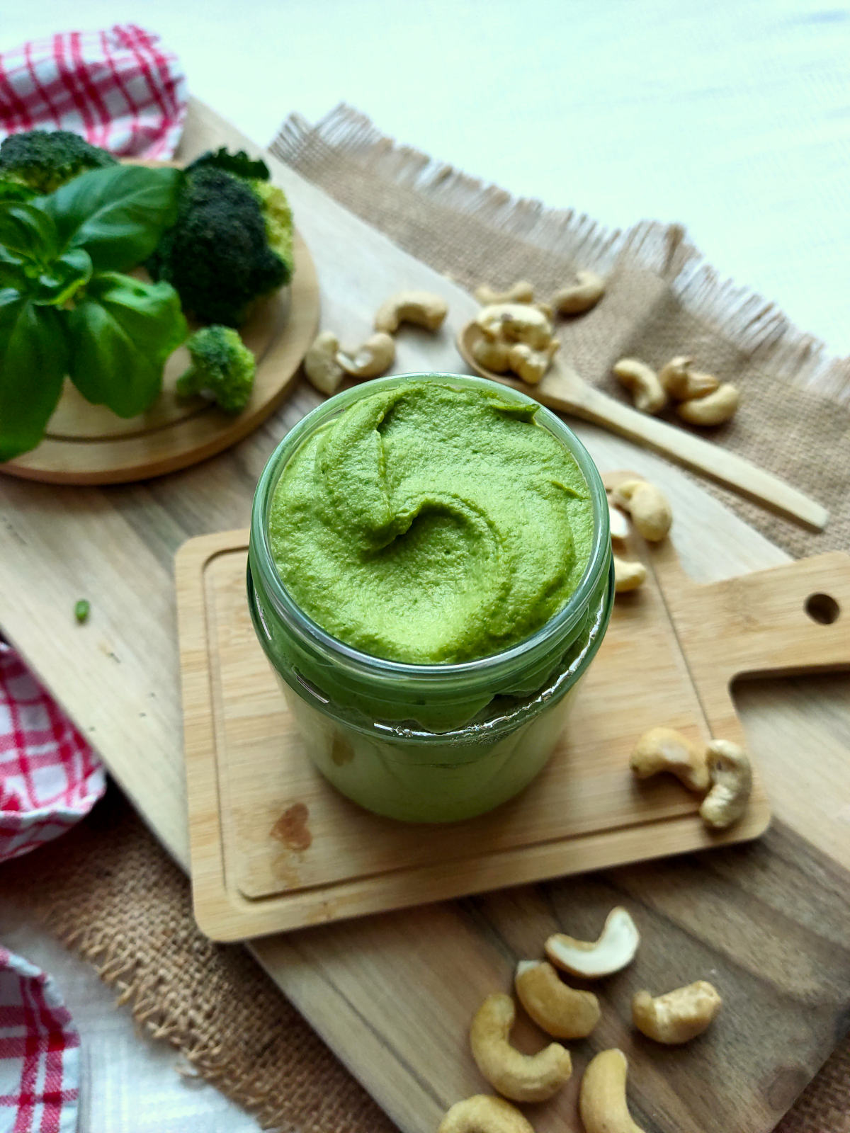 Green broccoli pesto bread spread in a jar