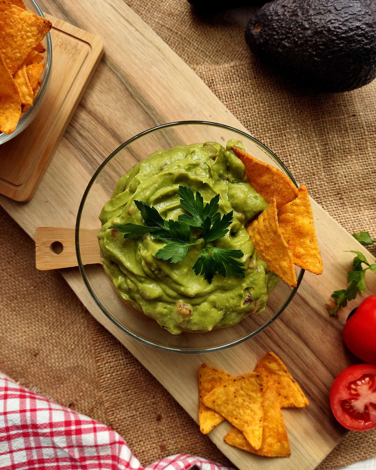 Guacamole in a bowl with tortilla chips on the side